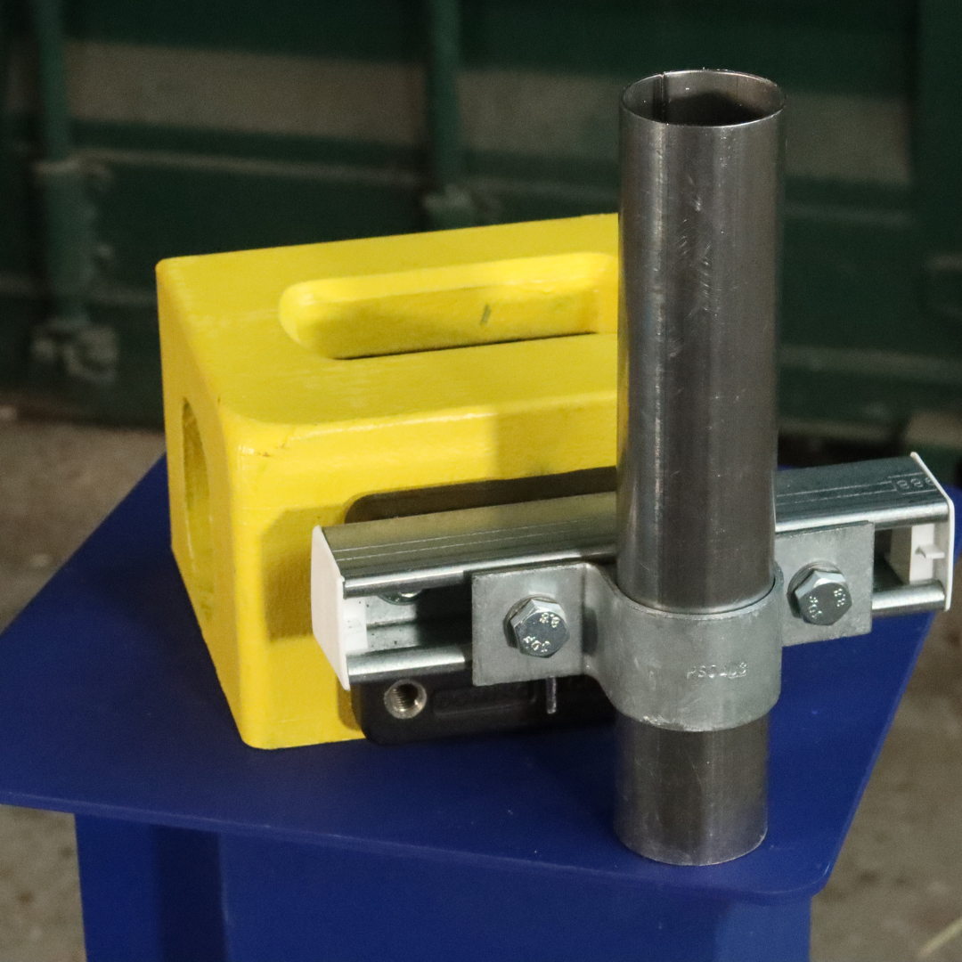 Unistrut Pipe Clamp size E 48-50mm attached to a shipping container corner casting