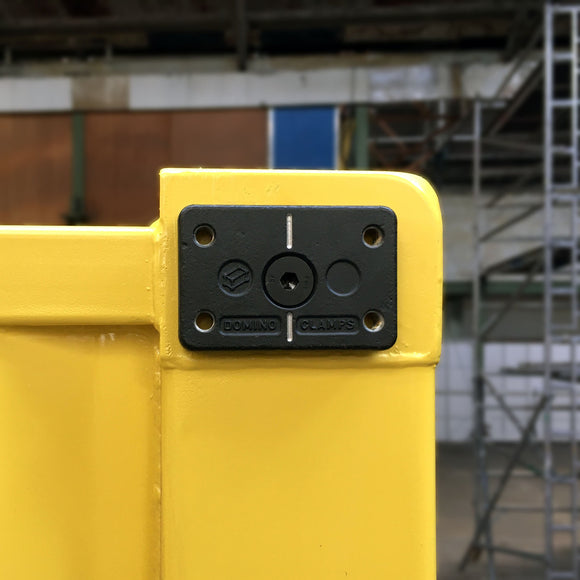 Front view of Domino Clamp attached to a shipping container