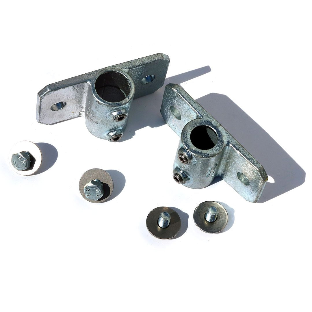 A pair of 34mm palm railing tube clamps with screws ans washers for bolting a 34mm steel tube to a shipping container using  a domino clamp 
